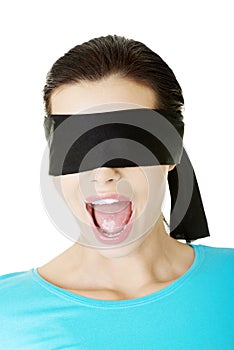 Portrait of a young blindfold woman screaming