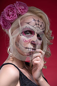 Portrait of young blond girl with Calaveras makeup