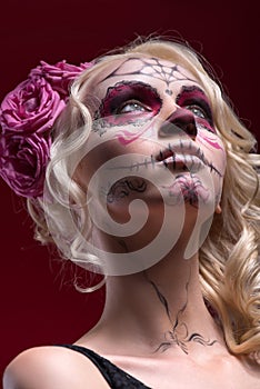 Portrait of young blond girl with Calaveras makeup