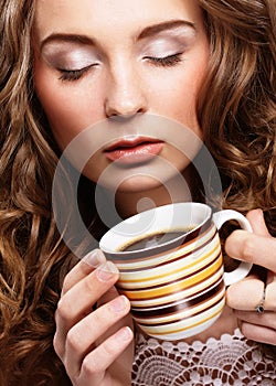 Portrait of young blond woman holding cafe cup close up