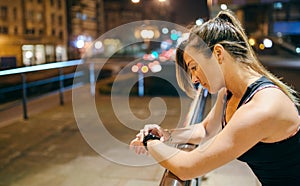 Portrait of young blonde runner woman looking heart rate monitor on smart watch app after training