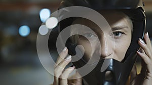 Portrait of young blonde woman with safety helmet in underground parking garage