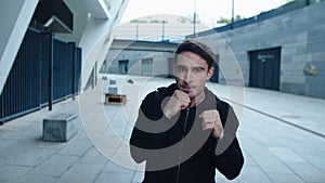 Portrait of young boxer training boxing exercise. Sportsman training punch