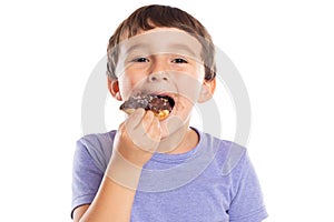 Portrait of a young boy child eating donut unhealthy sweet sweets isolated on white