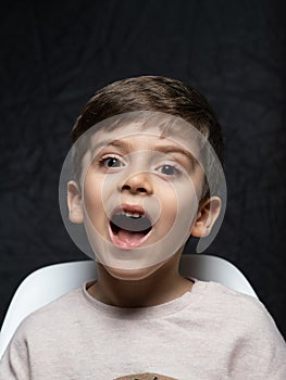 Portrait of an young boy on dark background