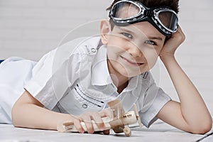 Portrait of a young boy with his hands in the air