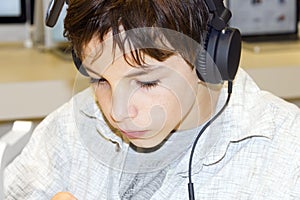 Portrait of a young boy listening to music on head