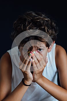 Portrait of a young boy looking upset and depressed, vertical image