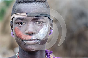 Portrait of a young boy from Mursi tribe, Ethiopia