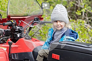 Portrait of young boy on quad bike