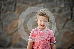 Portrait of Young Boy With Simple Rock Wall Background