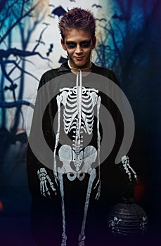 Portrait of young boy in skeleton costume with makeup. Celebration of holiday Halloween, the boy in the image, the skeleton theme