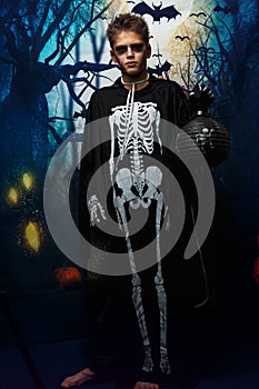 Portrait of young boy in skeleton costume with makeup. Celebration of holiday Halloween, the boy in the image, the skeleton theme