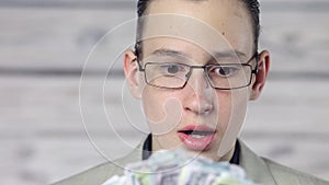 Portrait of a young boy surprised by money