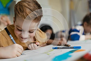 Portrait of young boy working on school project about wind energy.