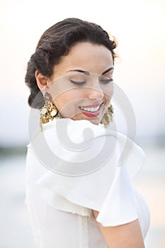 Portrait young bride with brunette hair in white wedding dress a
