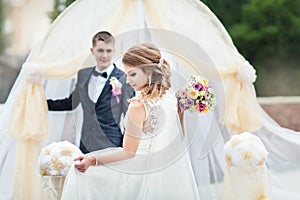 Portrait of a young bride and groom with a bouquet of flowers