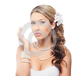Portrait of a young bride in pearl jewelry