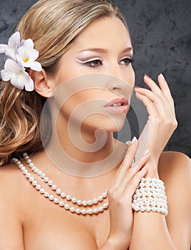 Portrait of a young bride in pearl jewelry