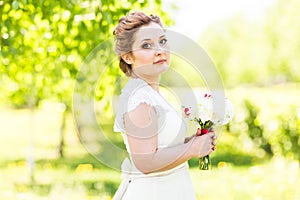 Portrait of young bride in the spring garden