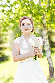 Portrait of young bride in the spring garden