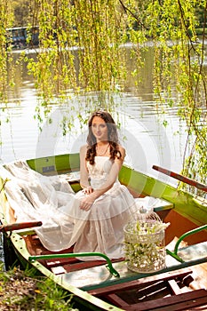 Portrait of young bride in stylish wedding dress on lake