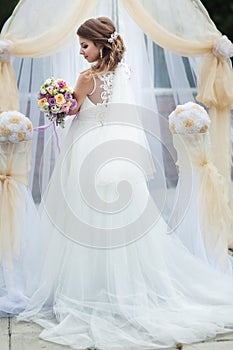 Portrait of a young bride in a white dress