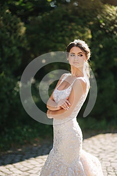 Portrait of young bride in white wedding dress outdoors. Fashion makeup