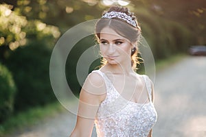 Portrait of young bride in white wedding dress outdoors. Fashion makeup