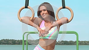 Portrait of young brown-haired woman outdoor at sport playground