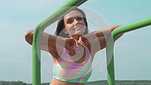 Portrait of young brown-haired woman outdoor at sport playground