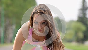 Portrait of young brown-haired woman outdoor at sport playground
