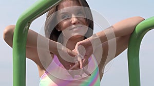 Portrait of young brown-haired woman outdoor at sport playground