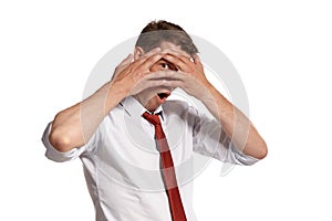 Portrait of a young brunet man posing in a studio isolated over a white background.