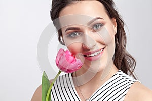 Portrait of young brunette beautiful woman with makeup in stripe