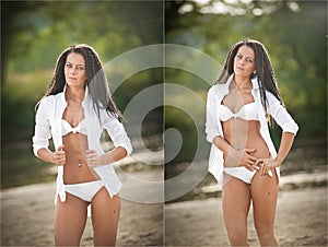 Portrait of young brunette girl in white swimsuit and male shirt posing on a beach with a forest in background