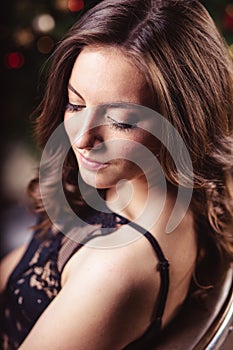 Portrait of young brunette woman in a black dress