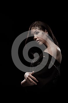 Portrait of a young brunette woman with black eyes and a lacy pattern on her face and neck