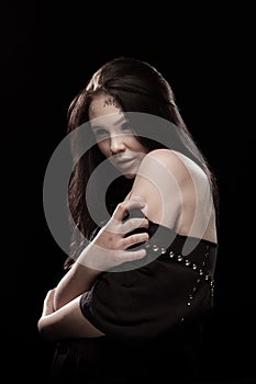 Portrait of a young brunette woman with black eyes and a lacy pattern on her face and neck