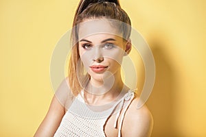 Portrait of young brunette woman with brown eyes.