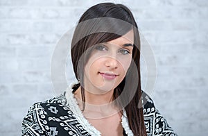 Portrait of a young brunette woman dressed with a black jacket