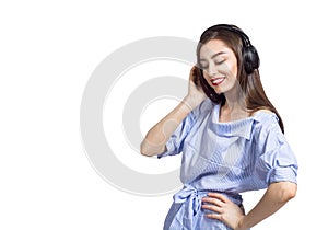 Portrait of a young brunette woman listening with closed eyes to the music with headphones against white background, isolated.