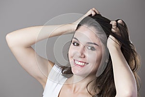 Portrait of a young brunette woman making faces with different e