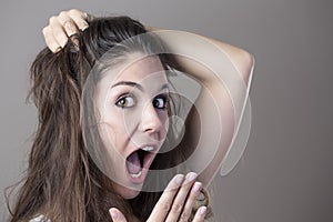 Portrait of a young brunette woman making faces with different e