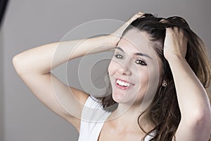 Portrait of a young brunette woman making faces with different e