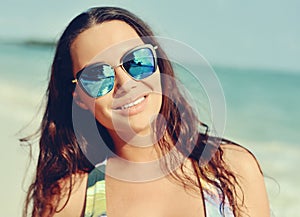 Portrait young brunette woman in sunglasees