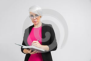 Portrait of young buisness lady in black costume isolated on background