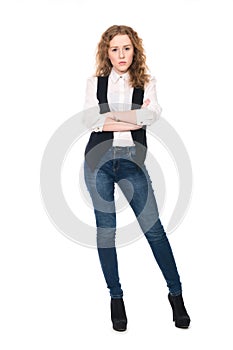 Portrait of young business girl with curly hair in jeans