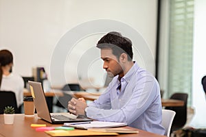Portrait of Young business indian man working