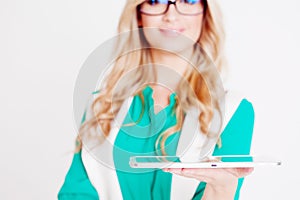 Portrait of young business lady in glasses, use tablet, white background, focus on the device